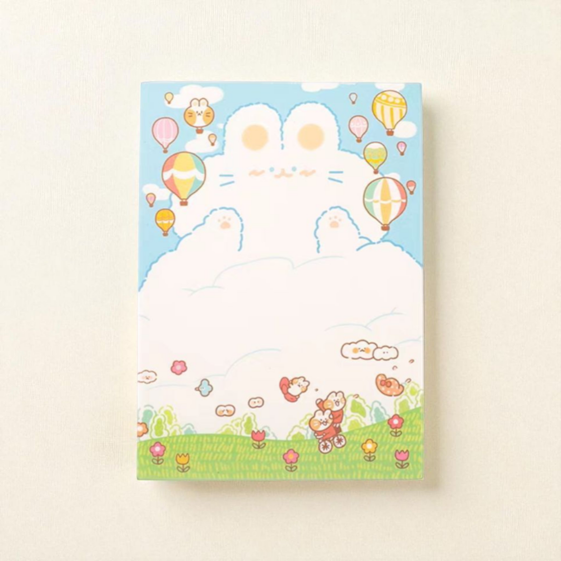 Cute A6 notepad featuring a cloud bunny in a blue sky with colorful hot air balloons and cheerful animals.