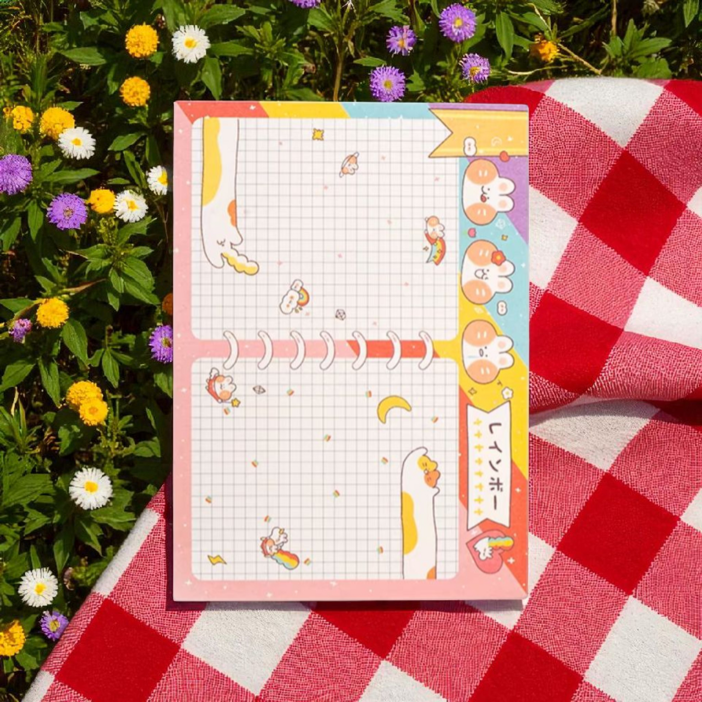Colorful A6 cute notepad featuring playful animals and a cheerful design on a picnic blanket with flowers.