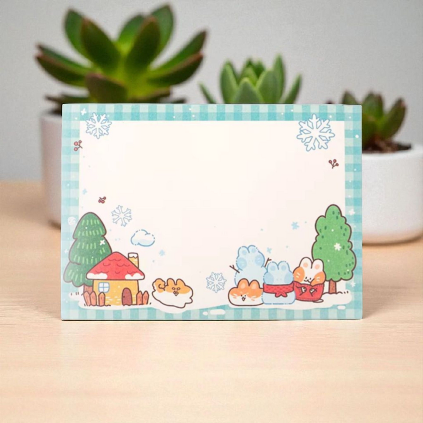 Cute blank notepad with whimsical animals and a colorful house design, set against a blue checkered border.